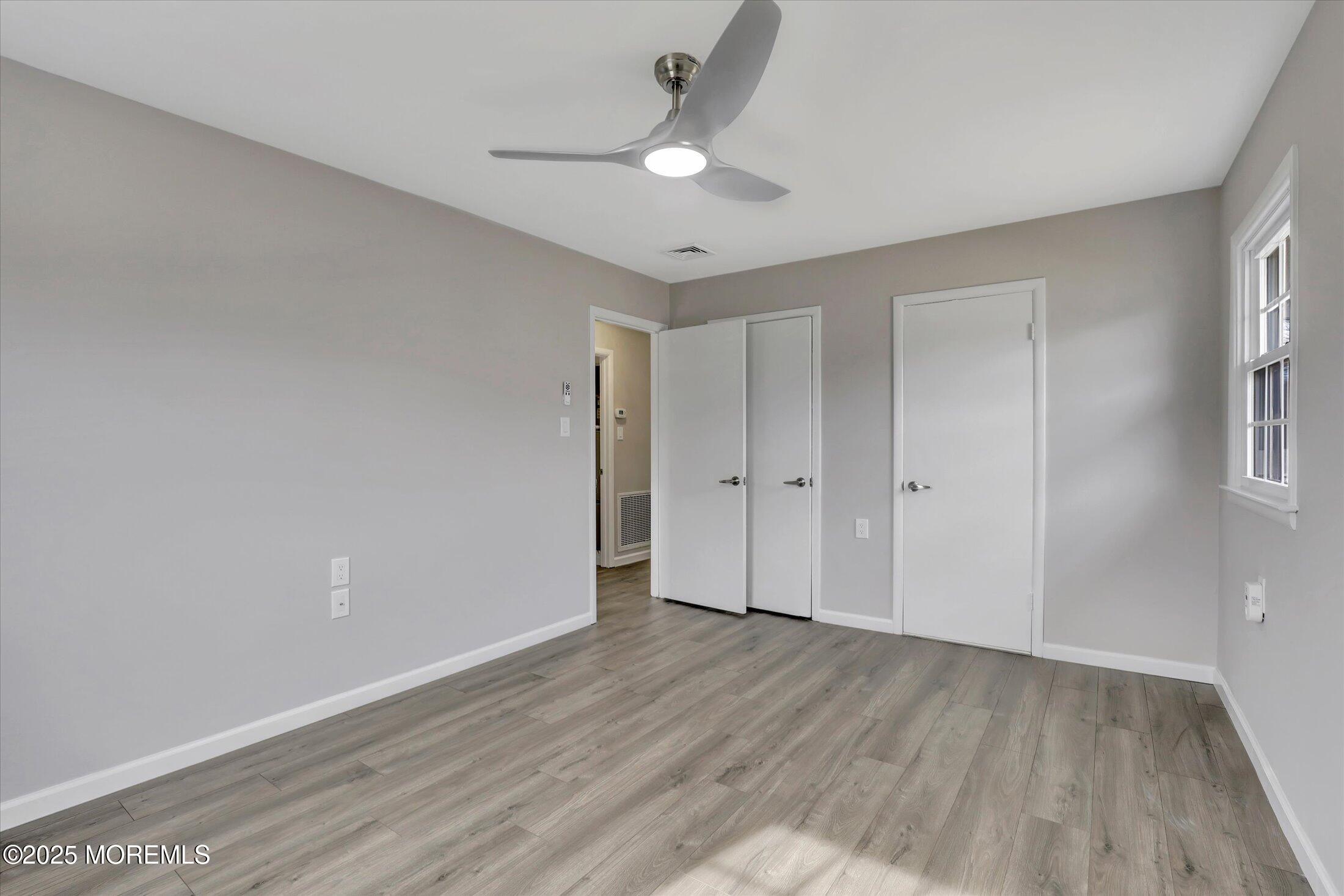 35 Patmore Road Brick, NJ 08724 - Photo 27 of 65 a view of an empty room with wooden floor and a window