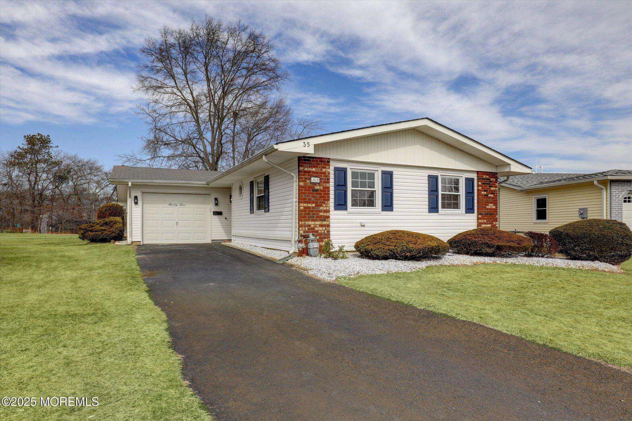 35 Patmore Road Brick, NJ 08724 - Photo 6 of 65 a front view of a house with a garden and yard