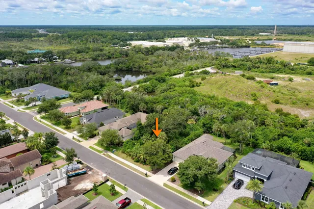 an aerial view of residential houses with outdoor space and street view