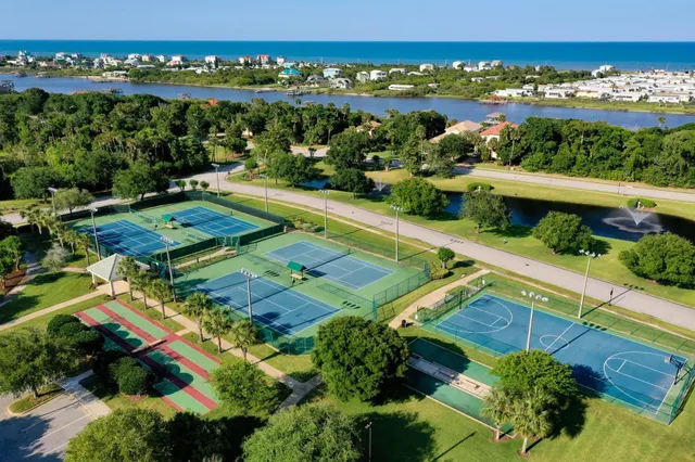 an aerial view of a house with a yard basket ball court and outdoor seating