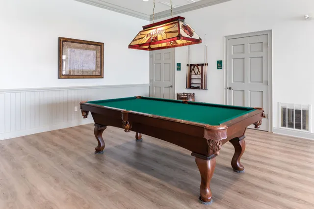 a room with furniture and pool table
