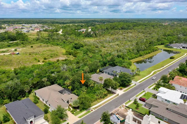 an aerial view of residential houses with outdoor space and street view