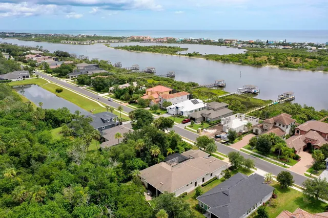 an aerial view of ocean and residential houses with outdoor space and ocean view