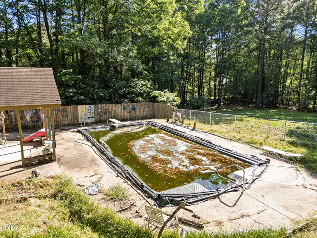 a backyard of a house with table and chairs