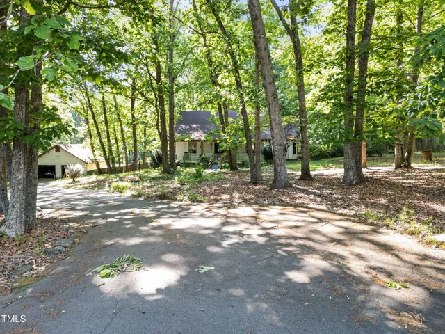 a view of a house with a yard and tree