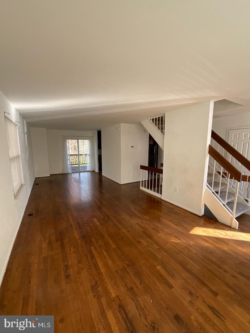 7109 Kurth Lane Lanham, MD 20706 - Photo 3 of 6 a view of empty room with wooden floor