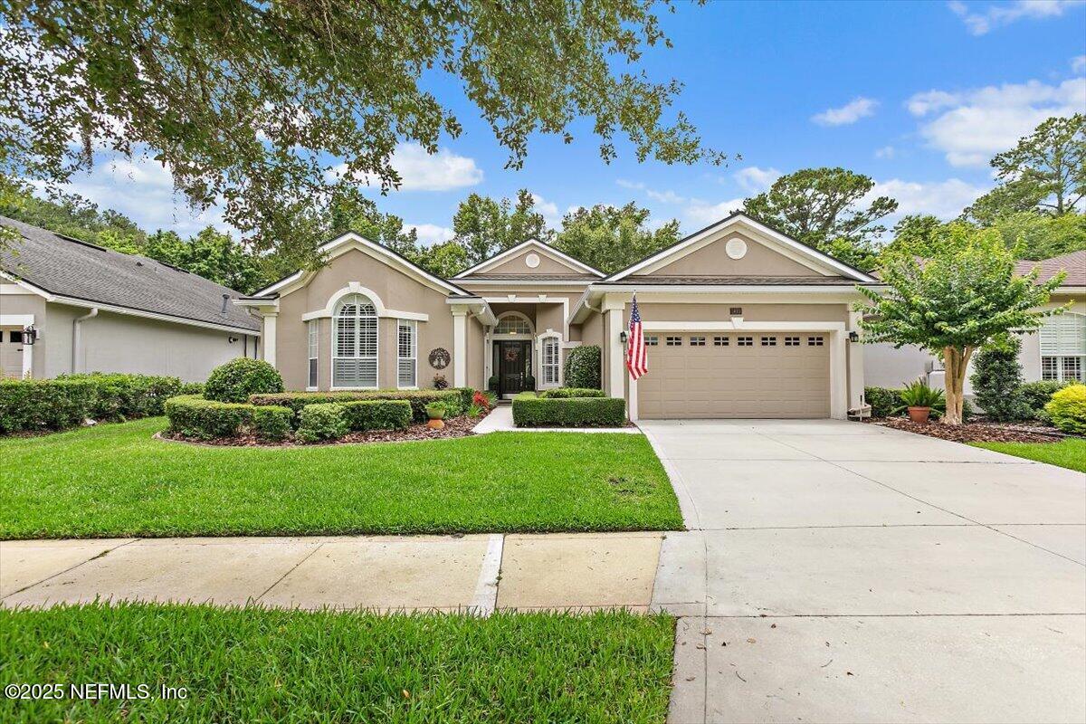 a front view of a house with a garden