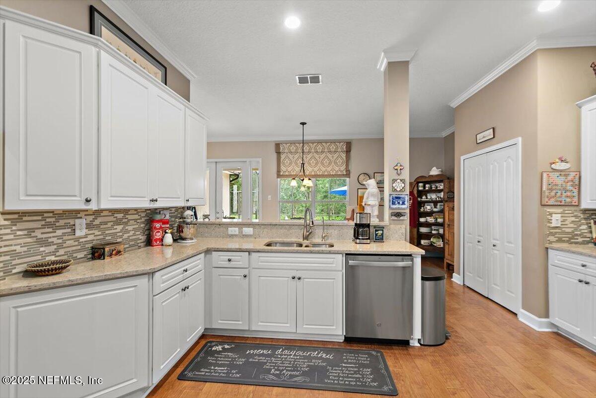 1400 Barrington Circle St. Augustine, FL 32092 - Photo 11 of 45 a kitchen with a sink stove and cabinets