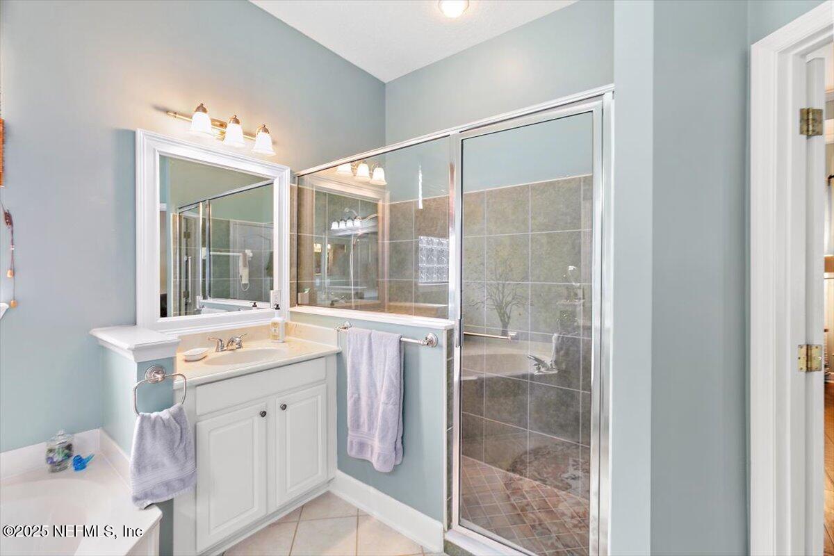 1400 Barrington Circle St. Augustine, FL 32092 - Photo 17 of 45 a bathroom with a sink vanity and mirror