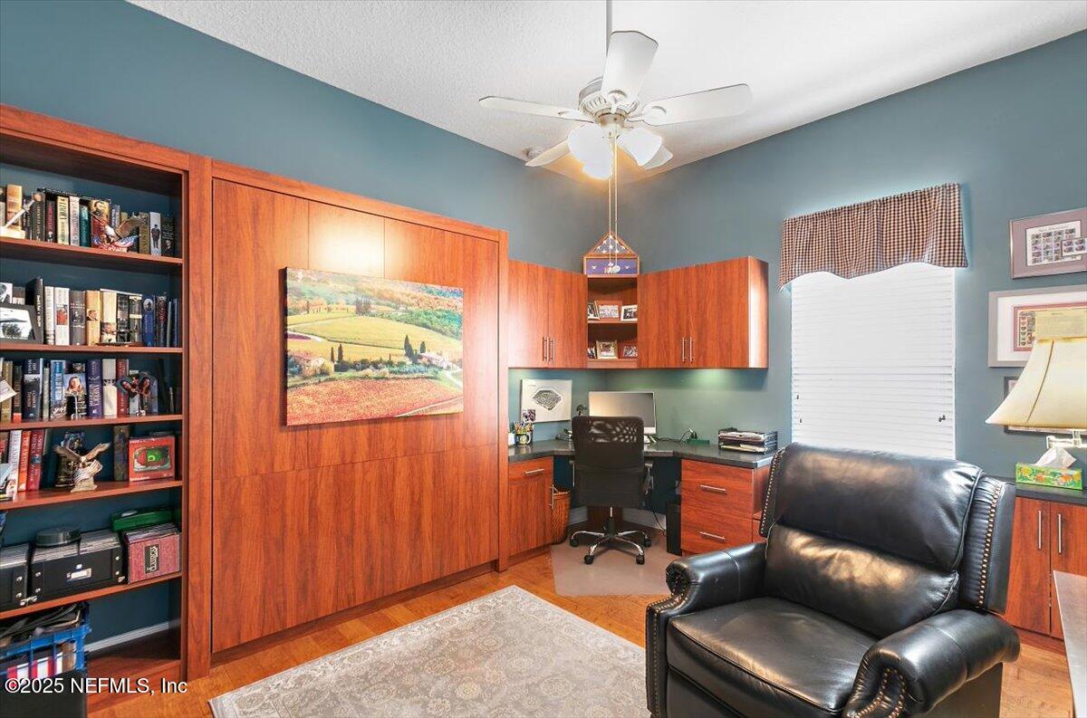 1400 Barrington Circle St. Augustine, FL 32092 - Photo 18 of 45 a work room with furniture a bookshelf and a window