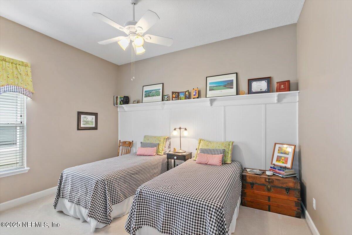 1400 Barrington Circle St. Augustine, FL 32092 - Photo 21 of 45 a bedroom with a bed and a chandelier