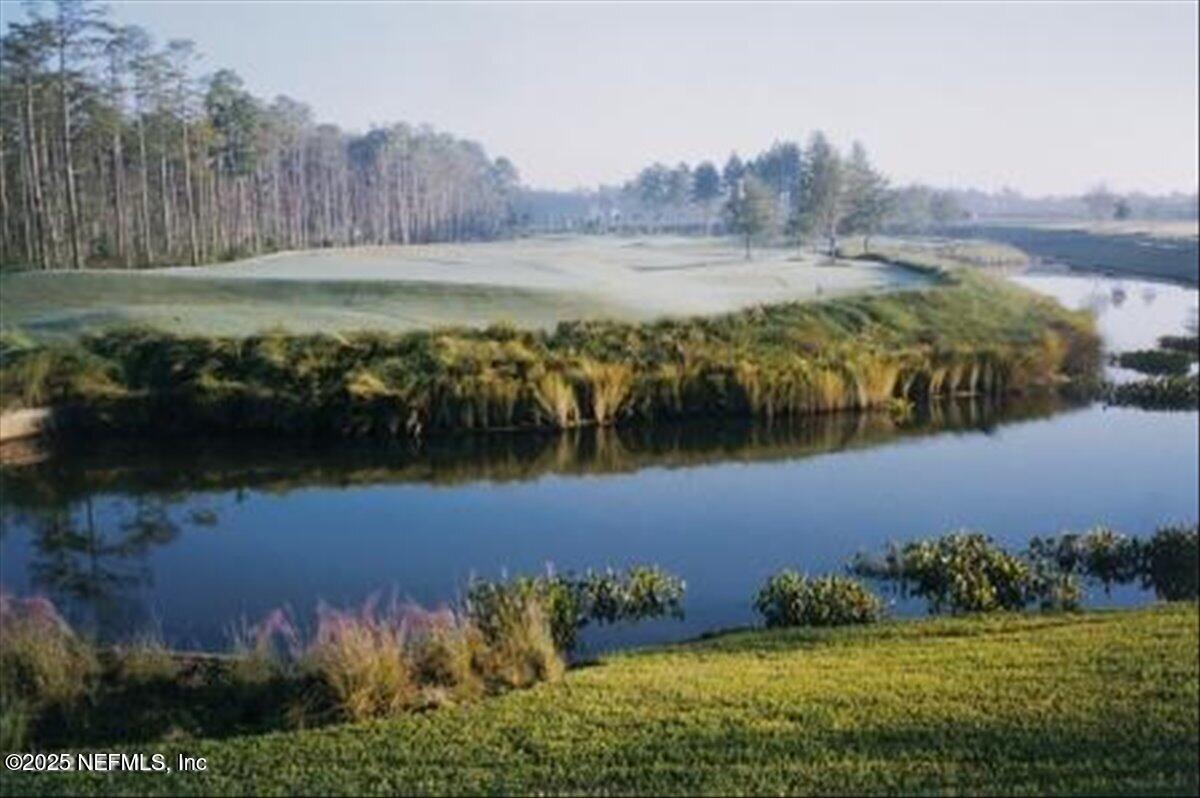 1400 Barrington Circle St. Augustine, FL 32092 - Photo 36 of 45 a view of a lake with a yard and a wooden bridge