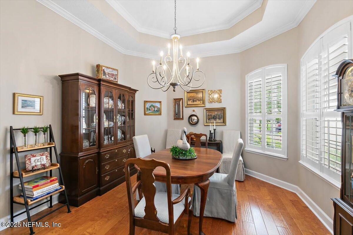 1400 Barrington Circle St. Augustine, FL 32092 - Photo 4 of 45 a view of a dining room with furniture a chandelier and wooden floor