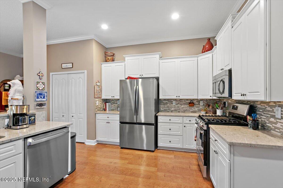 1400 Barrington Circle St. Augustine, FL 32092 - Photo 10 of 45 a kitchen with stainless steel appliances granite countertop a refrigerator a stove and a sink