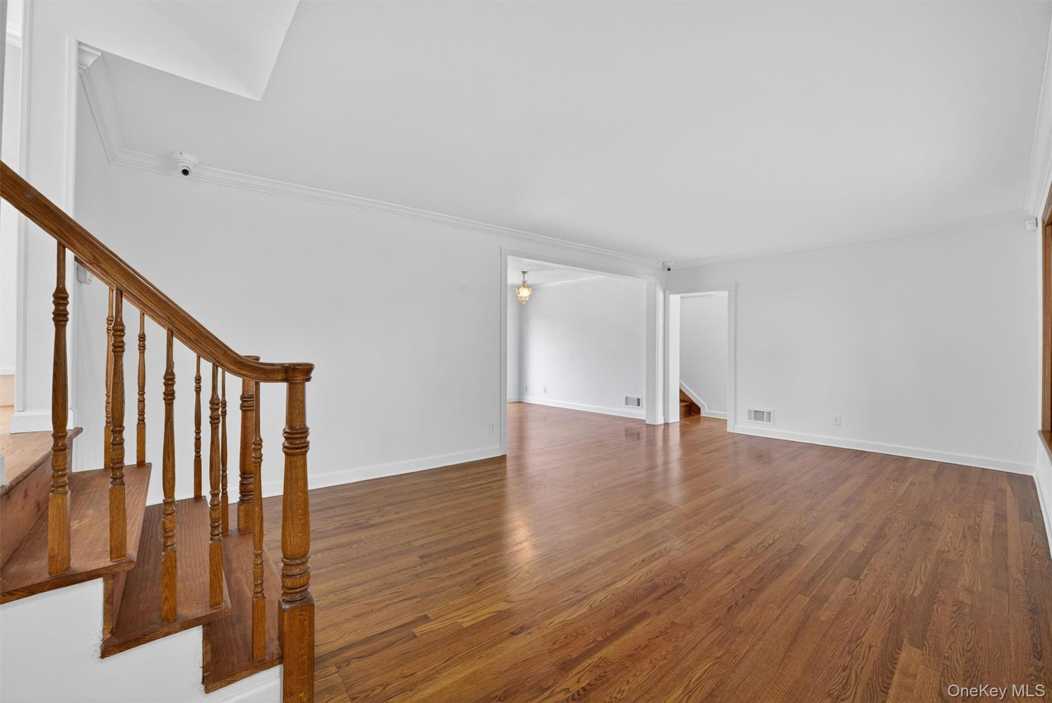 263 Croydon Road Yonkers, NY 10710 - Photo 4 of 43 a view of an empty room with wooden floor and stairs