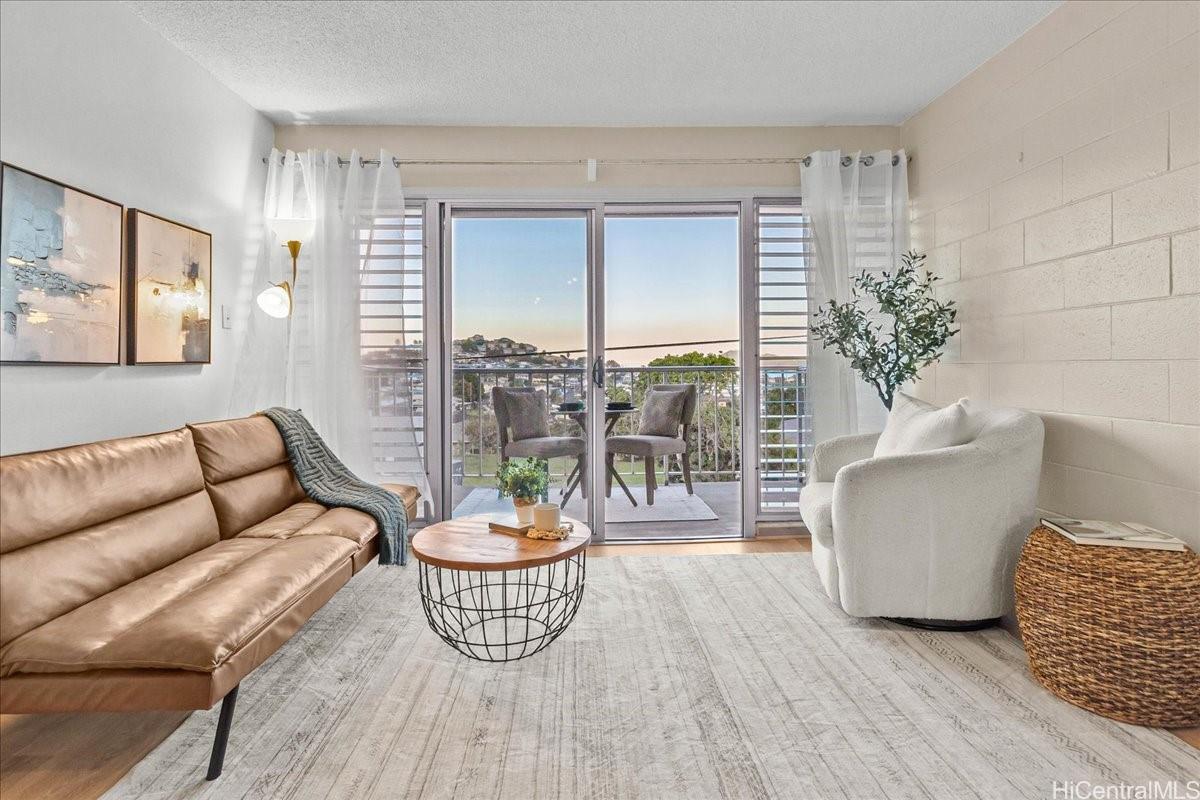 a living room with furniture and a potted plant