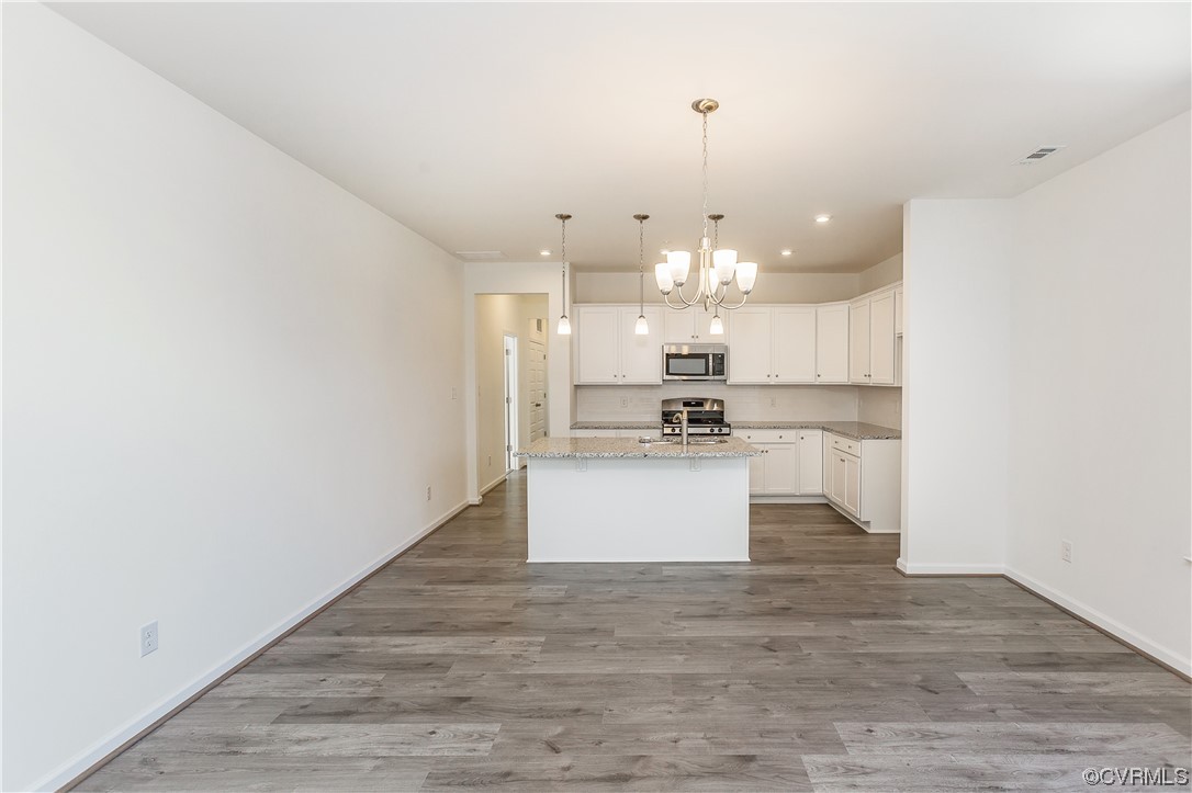 4119 Next Level Trace Midlothian, VA 23112 - Photo 11 of 50 a large kitchen with a refrigerator and wooden floor