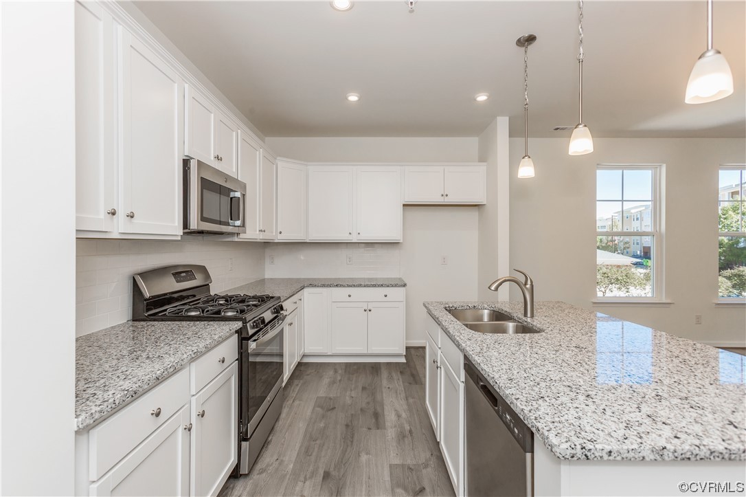 4119 Next Level Trace Midlothian, VA 23112 - Photo 16 of 50 a kitchen with granite countertop a sink a counter space appliances and cabinets