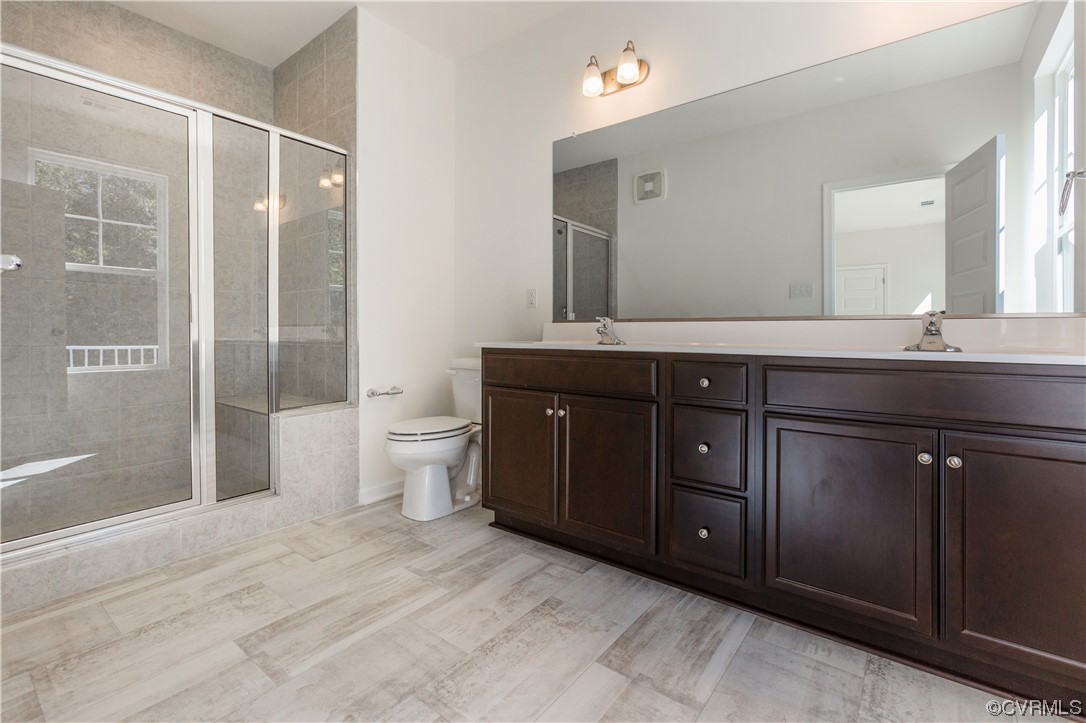 4119 Next Level Trace Midlothian, VA 23112 - Photo 23 of 50 a spacious bathroom with a granite countertop sink a toilet and a shower