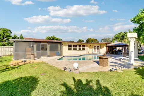 a front view of a house with a garden and yard