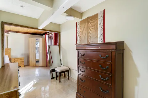 a bedroom with a bed and a mirror