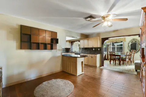 a living room with stainless steel appliances kitchen island granite countertop furniture and a kitchen view