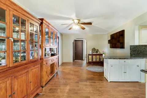 a large living room with stainless steel appliances furniture a fireplace and a flat screen tv