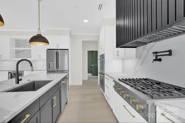 a kitchen with sink a stove and cabinets