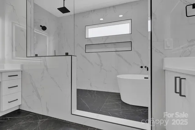 a bathroom with a bathtub and a shower