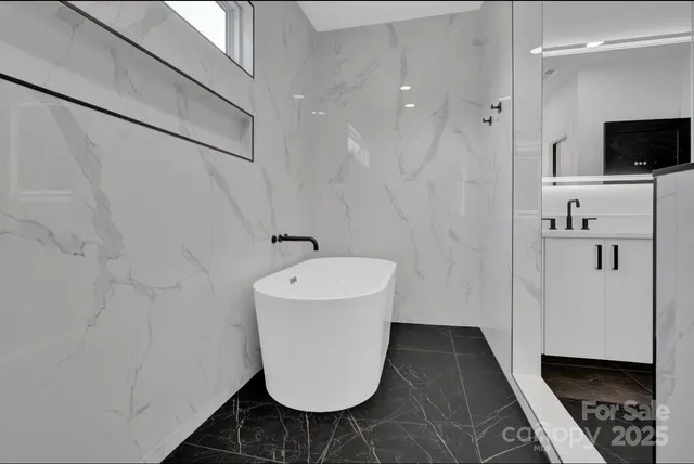 a bathroom with a bathtub and a shower