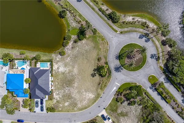 an aerial view of a house with a swimming pool and outdoor seating