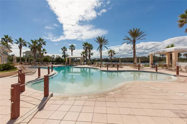 a view of a swimming pool with outdoor seating
