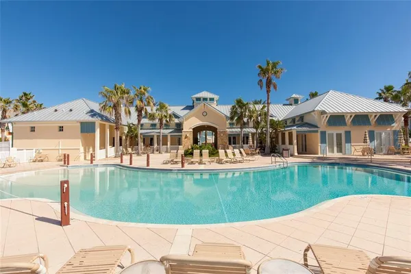 a swimming pool with outdoor seating and yard