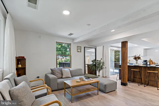 a living room with furniture and wooden floor