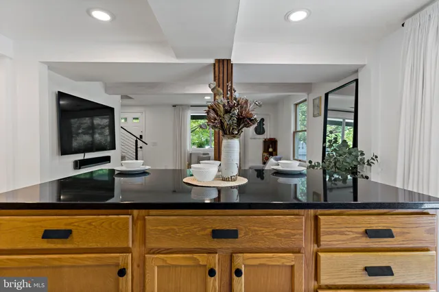 a kitchen with stainless steel appliances granite countertop a sink and a white cabinets