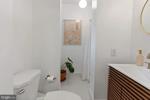 a bathroom with a sink toilet and a mirror