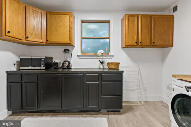 a kitchen with a sink a cabinets and window