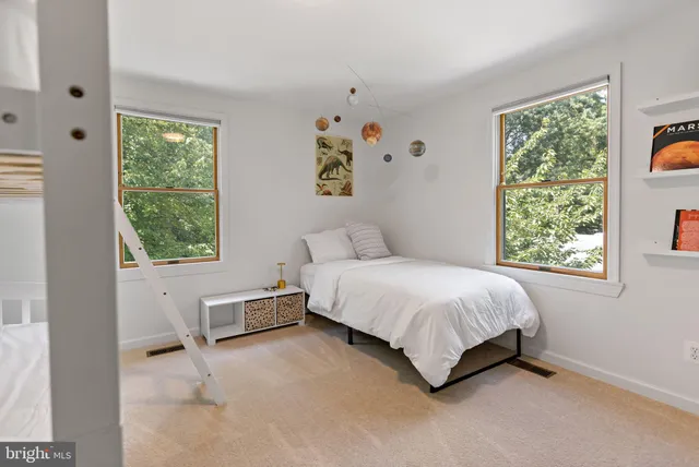 a spacious bedroom with a bed and a window