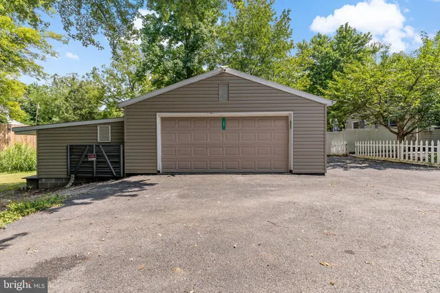 a view of garage yard and large tree