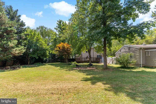 a swimming pool with outdoor seating and yard