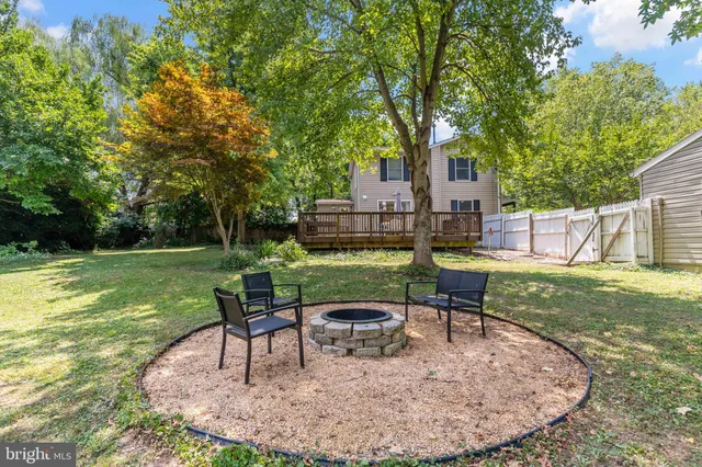 a view of a house with backyard sitting area and garden