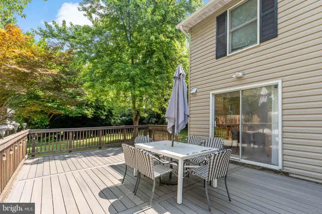 a view of a chairs and table on the wooden deck