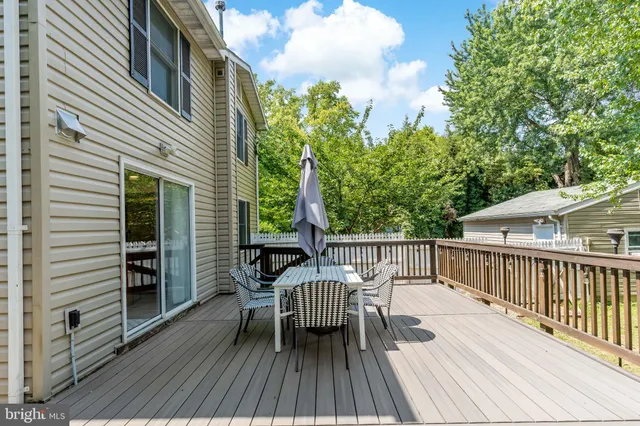 a view of a roof deck with table and chairs and wooden floor