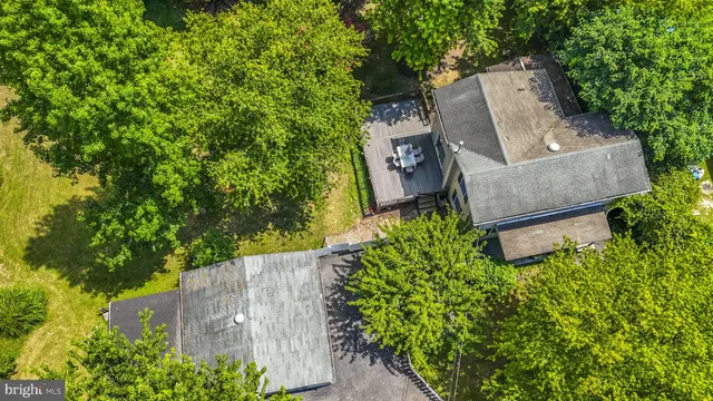 an aerial view of a house with a yard and garden