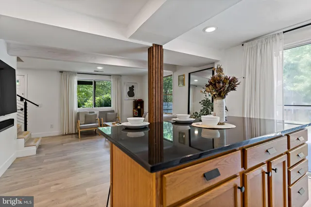 a kitchen with counter top space and living room