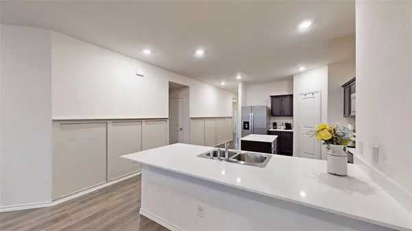 a kitchen with refrigerator and a sink