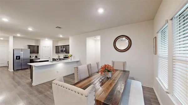 a view of kitchen with stainless steel appliances granite countertop lots of counter top space