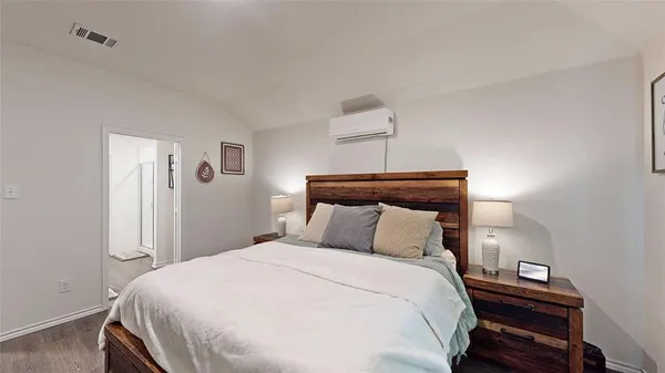 a bedroom with a bed and a night stand