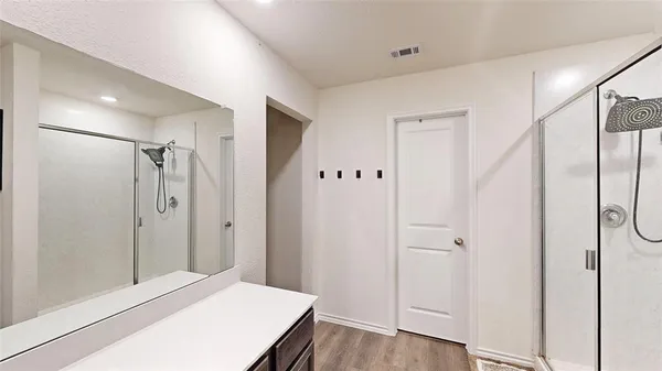 a view of a hallway with wooden floor