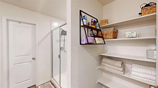 a view of a hallway with paintings on the wall